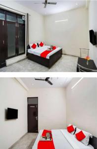 um quarto com 2 camas com almofadas vermelhas e uma televisão em Hotel Heaven residency em Greater Noida