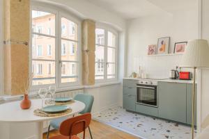 a kitchen with a table and chairs in a room at Design et cosy en hypercentre in Lyon