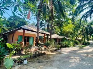 a small house in the middle of a forest at Marina Resort Koh Phayam Ranong in Ko Phayam