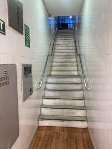 a stairway in a subway station with a sign at Hotel Angely in Belo Horizonte