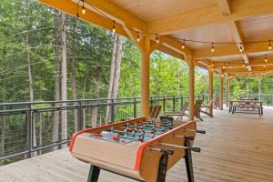 a wooden deck with a foosball table at Huttopia Adirondacks in Lake Luzerne