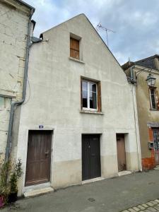 a white building with two doors and two windows at Le Doux Douillet Beauval à 5mn du Zoo - Gite Familial en Hypercentre de Saint-Aignan in Saint-Aignan