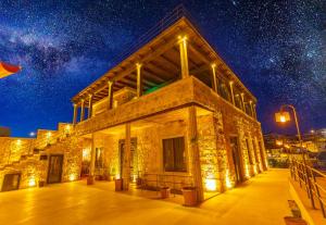 a building at night with a starry sky at Megaron Cave Hotel Cappadocia in Ortahisar
