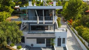 an overhead view of a white house with trees at Mathesi apartment Sea front in Elia