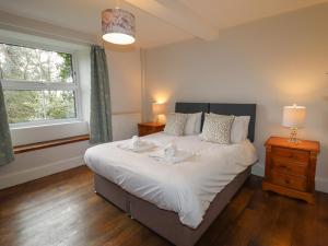 a bedroom with a large bed and a window at Wayside House in Craven Arms