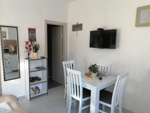 a dining room with a white table and chairs at Apartments Željka-Dobrota in Kotor