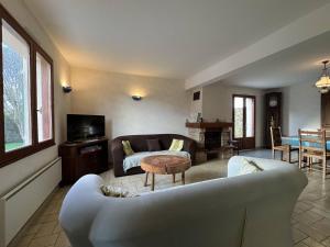a living room with a couch and a table at 350 - Charmante maison dans le bourg de Plévenon à 1 kilomètre des plages in Plévenon