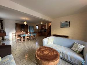 a living room with a couch and a table at 350 - Charmante maison dans le bourg de Plévenon à 1 kilomètre des plages in Plévenon