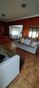 a living room with a couch and a table at Casa, quincho, garage y parque.apta 10 personas in Mar del Plata
