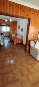 a large living room with a couch and a table at Casa, quincho, garage y parque.apta 10 personas in Mar del Plata