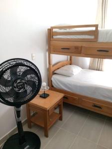a room with a fan next to a bunk bed at Apartamento los Aces in Ricaurte