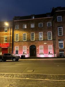 a large brick building with a black car parked in front at Duke Street Townhouse in Liverpool