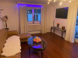 a living room with a couch and a table at Apartmenthaus Sonnenblick in Binz