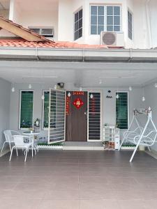 a patio with a door and a table and chairs at Double storey and half 4r3b karaoke lami in Cheras