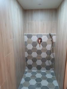 a man taking a picture of a shower in a bathroom at Chambre Les étoiles de Bevy in Molunes