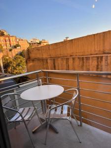 a table and two chairs sitting on a balcony at Greysuites in Kavála
