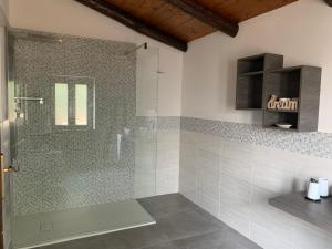 a bathroom with a shower with a glass door at B&B La Lanterna in Verbania