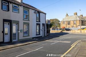 an empty street with a building on the side of the road at Eden Rose Cottage in Morecambe