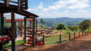 a restaurant with a view of a hill with a fence at Chalés do Gigante in Pardinho +30 photos