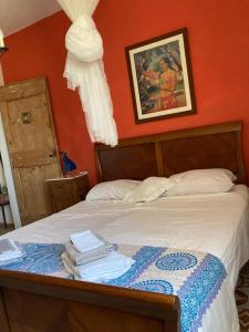 a bedroom with a bed with a painting on the wall at Residenza al Gelso in Marsala