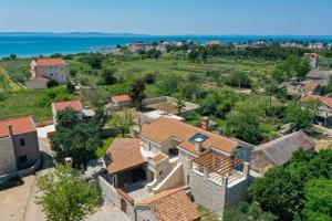 an aerial view of a house with the ocean in the background at Castello Exclusive rooms with breakfast - by TA Leut Agency in Privlaka