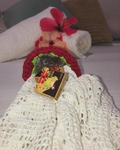 a book on a blanket on a bed at Village verde in Itacaré