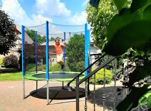 a woman is jumping on a trampoline at B&B Penzión Magura in Bardejov