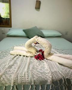 a bed with two swans made out of towels at Village verde in Itacaré