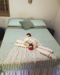 a woman in a dress laying on a bed at Village verde in Itacaré