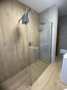 a shower with a glass door in a bathroom at Mountain Apartments Tarvisio in Tarvisio