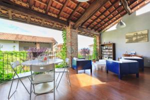 a patio with a table and chairs on a deck at Antica Casa Balsari in Borgo Ticino
