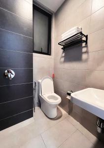 y baño con aseo y lavamanos. en Urban Suites Jelutong Georgetown, en Jelutong