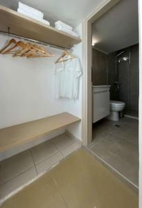 a bathroom with a toilet and white towels at VistaMare2 Double room-sea view in Koutsourás