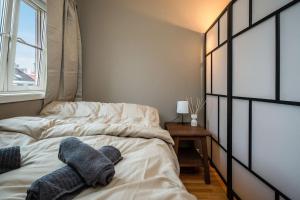 a bedroom with two beds with towels on it at Studio apt in city centre in Trondheim