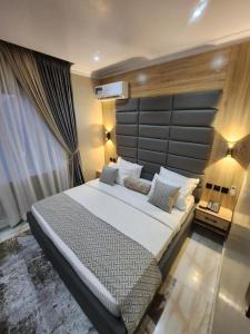 a bedroom with a large bed in a room at Atlantic Palms Suites in Lekki