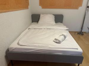 a bed with two pillows and a sock on it at Wohnung mit top Küche in Untermeitingen