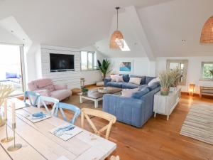 a living room with a couch and a table at Sea View House in Newquay