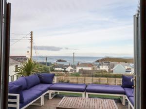 a balcony with purple couches and a view of the ocean at Sea View House in Newquay