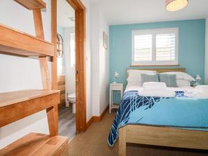 a bedroom with a bed with a blue wall at Sea View House in Newquay