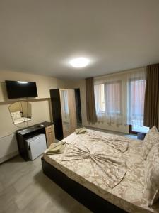 1 dormitorio con 1 cama grande y TV en Guest Rooms Wild Duck, en Ezerets