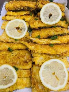 a plate of food with lemon slices on it at NN Jacaranda Guesthouse in Newcastle