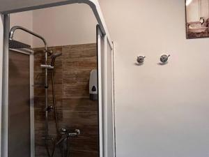 a shower with a glass door in a bathroom at Catina Domus in Catania