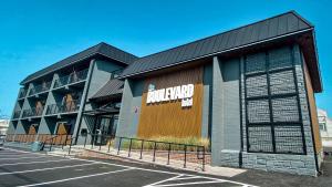 a parking lot in front of a building at The Boulevard Hotel in Beach Haven Gardens