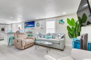 a living room with a couch and a chair at Gulf Breeze Home with Deck Walk to Public Boat Ramp in Oriole Beach