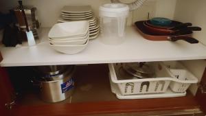 a kitchen shelf with plates and dishes on it at UE Home 203 in Duitama