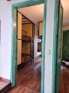 una puerta abierta a una habitación con cama en MAMBE HOSTEL en Bogotá