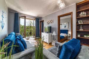 a living room with a couch and a tv at Apartamenty Rozewie in Jastrzębia Góra