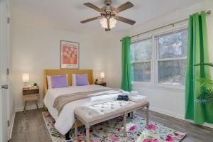 a bedroom with a large bed with green curtains at 15mins AU & Golf: 4bd - Eclectic - BBQ Grill in Augusta