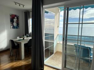 Cette chambre dispose d'une table et offre une vue sur l'océan. dans l'établissement Altea seafront - Primera linea, à Altea