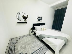 a bedroom with two beds and a mirror on the wall at Adamhawa Homestay Emerald Avenue Brinchang in Brinchang